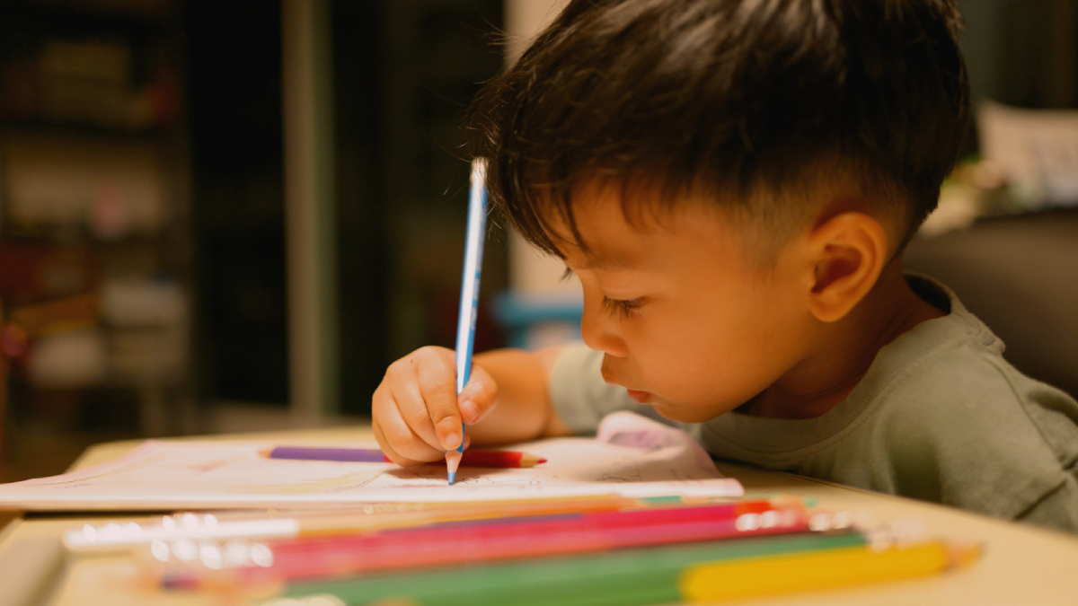 Young boy doing homework.